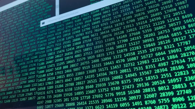 Digital interface displaying streams of green numerical data for Health Information Management systems.
