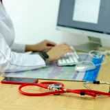 A healthcare professional using a computer for efficient management for health information.