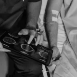 Healthcare professional using a tablet to review brain scans as part of AI In Patient Support.