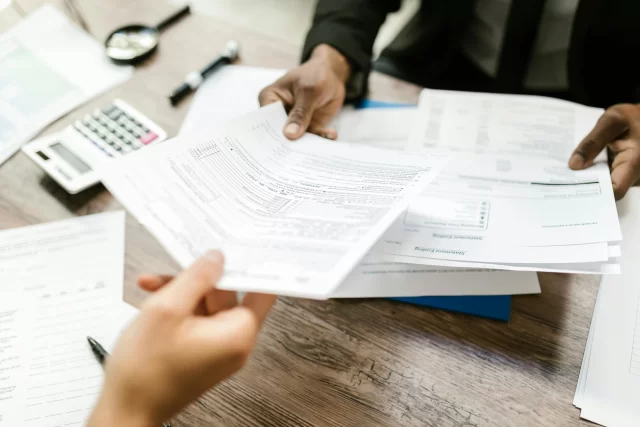 Professional handing over tax documents for the International Medical Group in Switzerland.