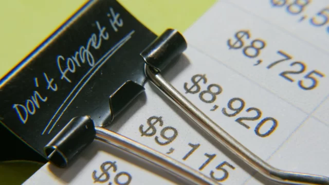 Financial records featuring a binder clip with the reminder "Don't forget it," highlighting medical information management for Lucerne.