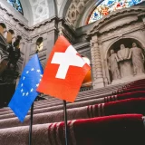 European Union and Swiss flags displayed in a government building, representing healthcare information management in Basel.